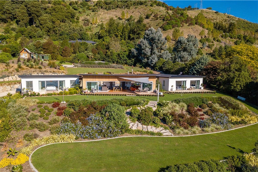 A completed hillside residence in New Zealand, set in landscaped grounds