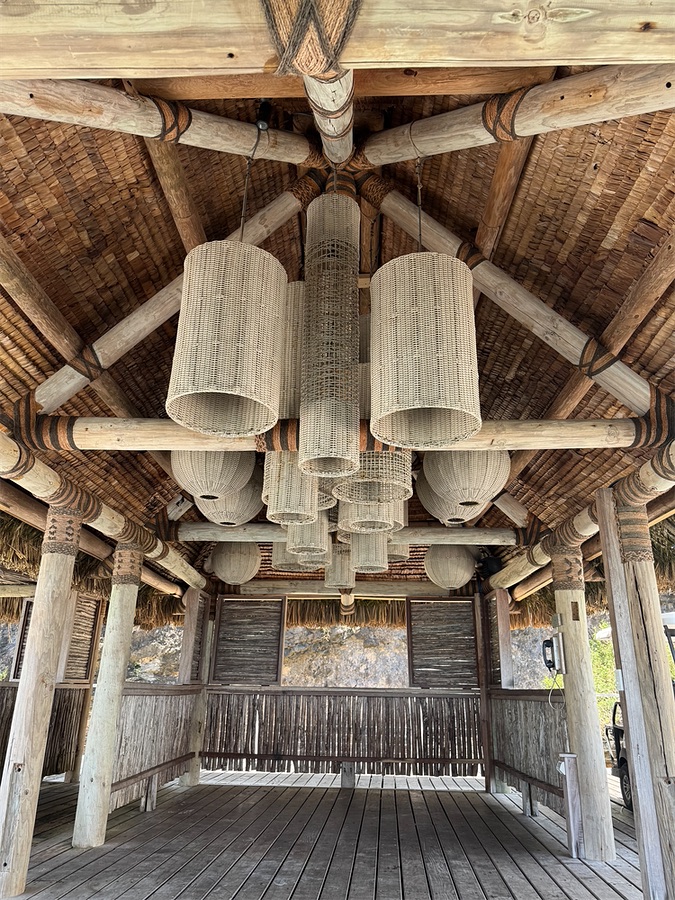 Over-water pavilion with woven lanterns
