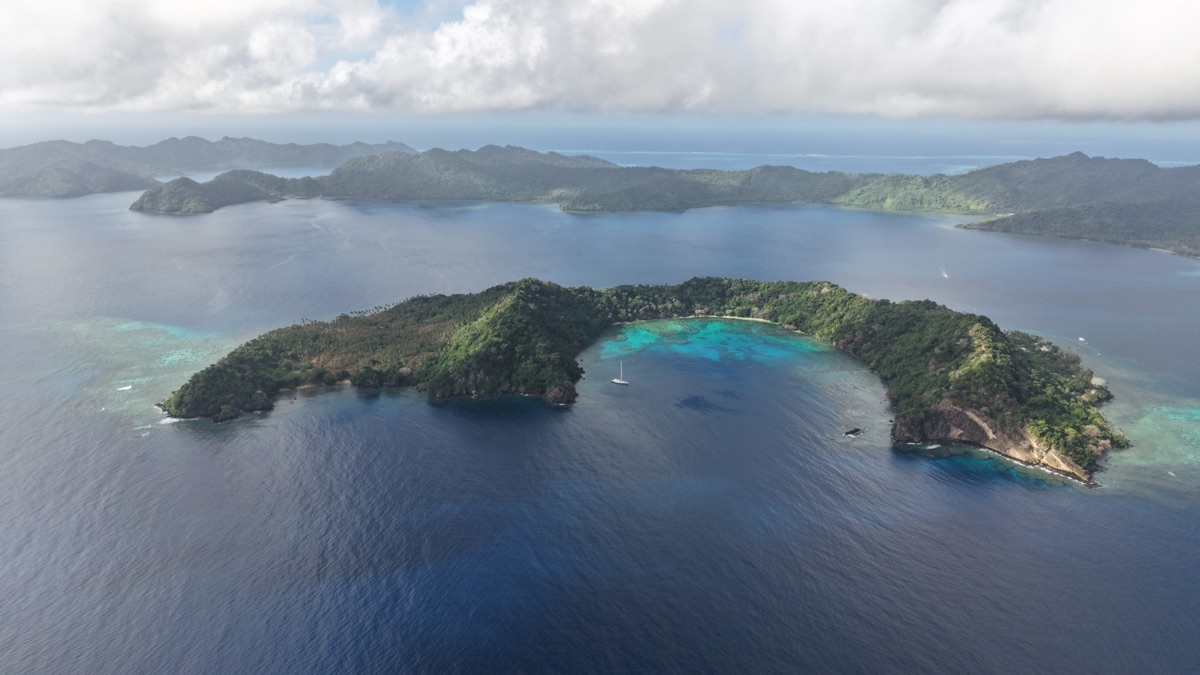 Matagi Island from the air, with its horseshoe bay and reef