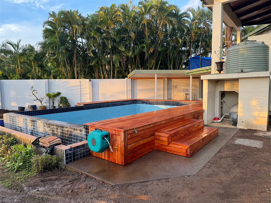 Timber-clad pool surround with built-in steps